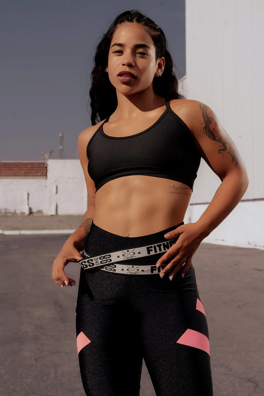 Woman in workout clothes standing outdoors